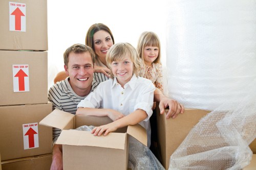 Family and student moving boxes using removal truck hire in Balham