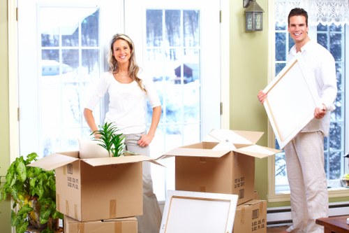 Professional movers carrying household furniture during a Balham house move