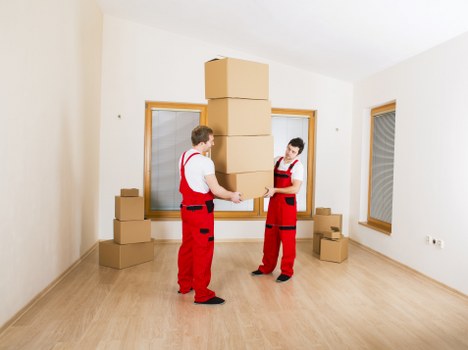 Local team carrying furniture down stairs during a Balham collection